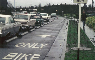 empty bike lane next to cars in bumper to bumper traffic